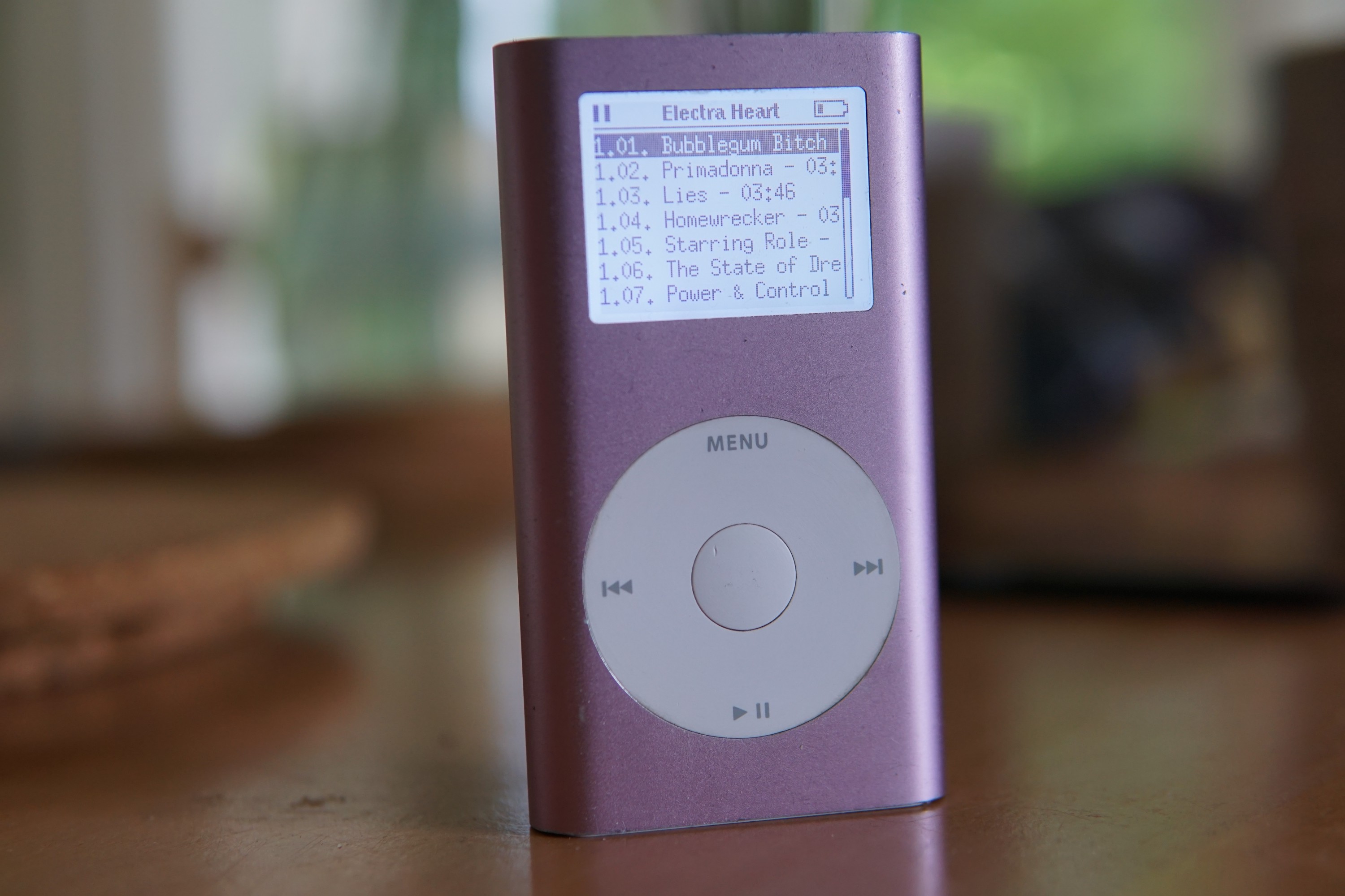 an iPod mini, with the album listing for Electra Heart by Marina on the display