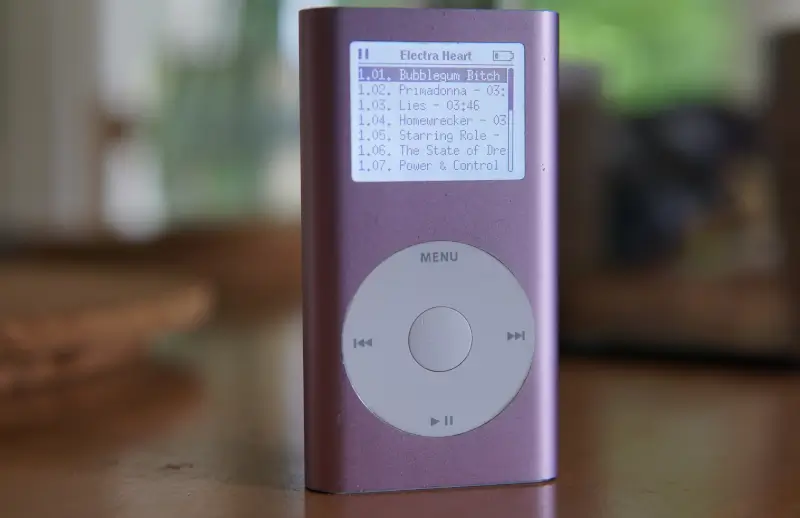 an iPod mini, with the album listing for Electra Heart by Marina on the display